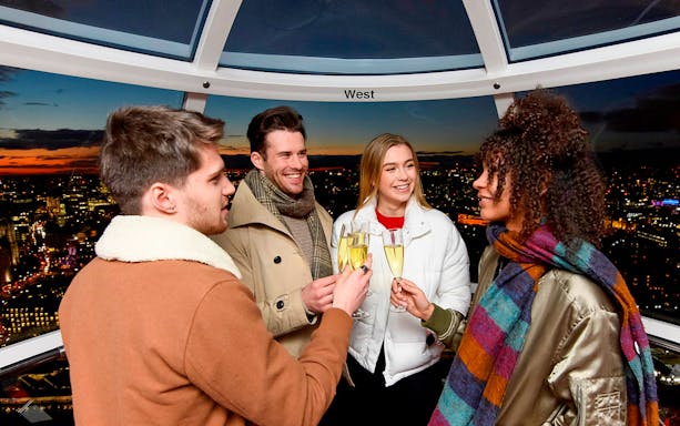 Group enjoying champagne inside London Eye capsule at sunset.