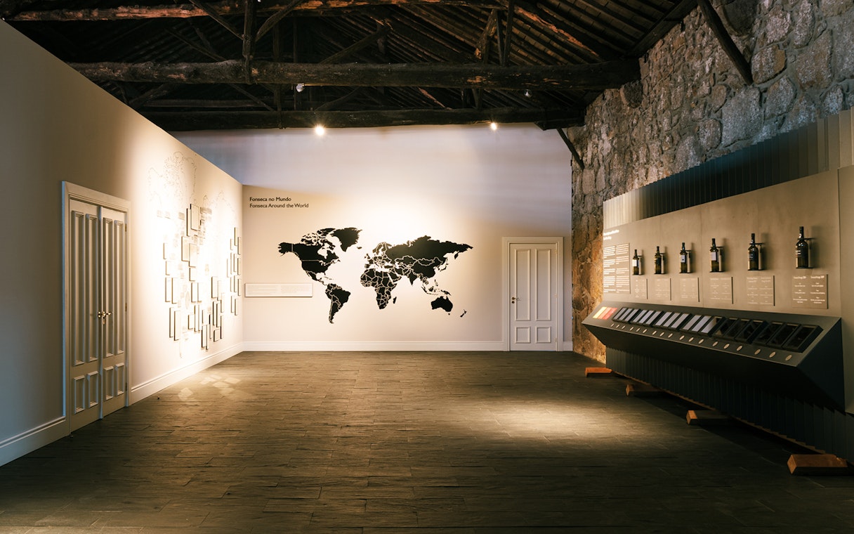 Fonseca port wine cellar interior with world map display and wine bottles.