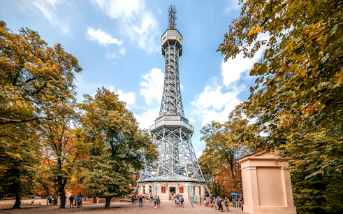 Petrin Tower exterior surrounded by trees in Prague, Czech Republic.