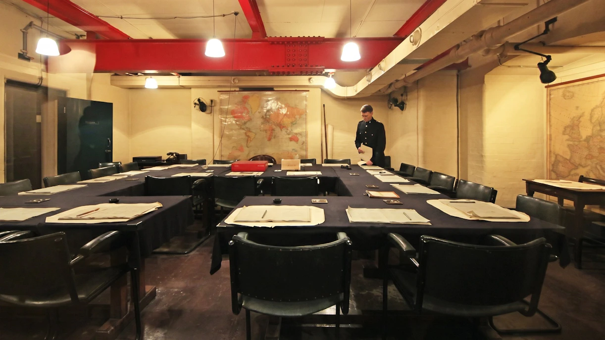 Meeting room in Churchill War Rooms, London, with historical maps and documents.