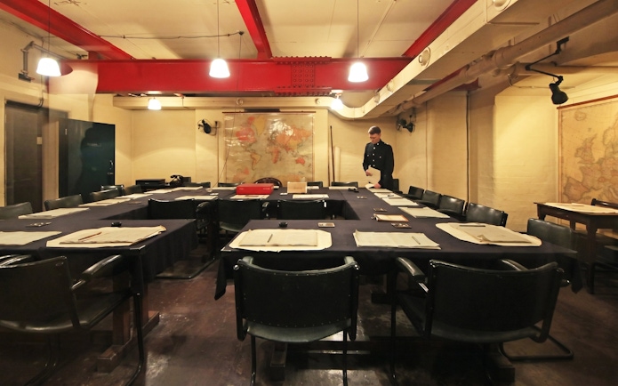 Meeting room in Churchill War Rooms, London, with historical maps and documents.