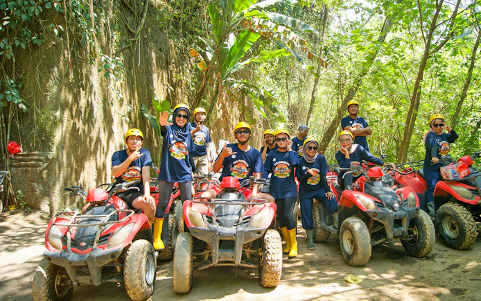 Group on ATVs during Bali quad bike tour in lush forest setting.