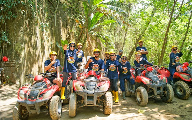 Group on ATVs during Bali quad bike tour in lush forest setting.