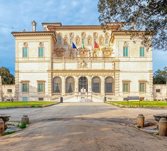 Villa Borghese facade with flags at sunset, Rome, Italy.