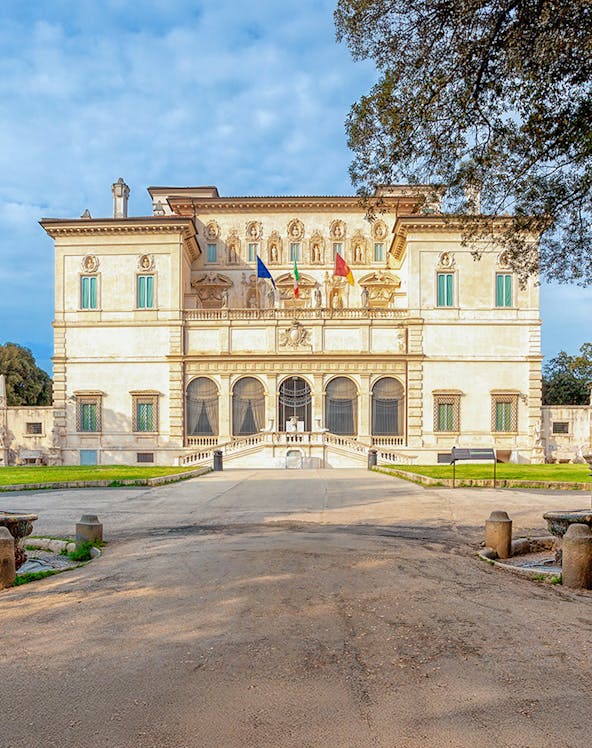 Villa Borghese facade with flags at sunset, Rome, Italy.