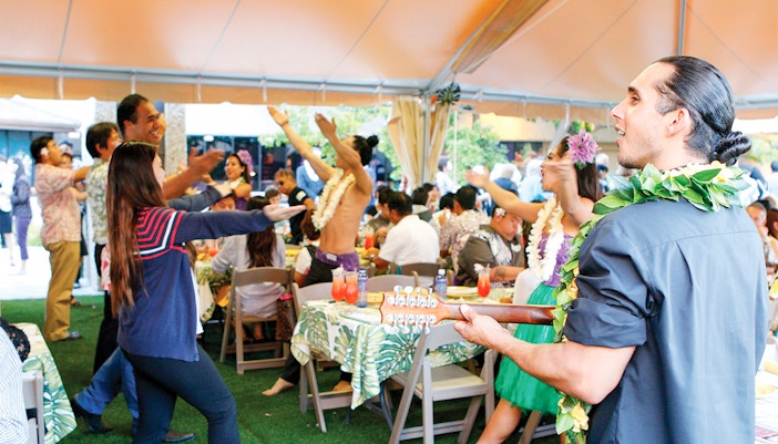 Artists perform with ukulele as guests enjoy Waikiki Luau Buffet before Rock-A-Hula Show.