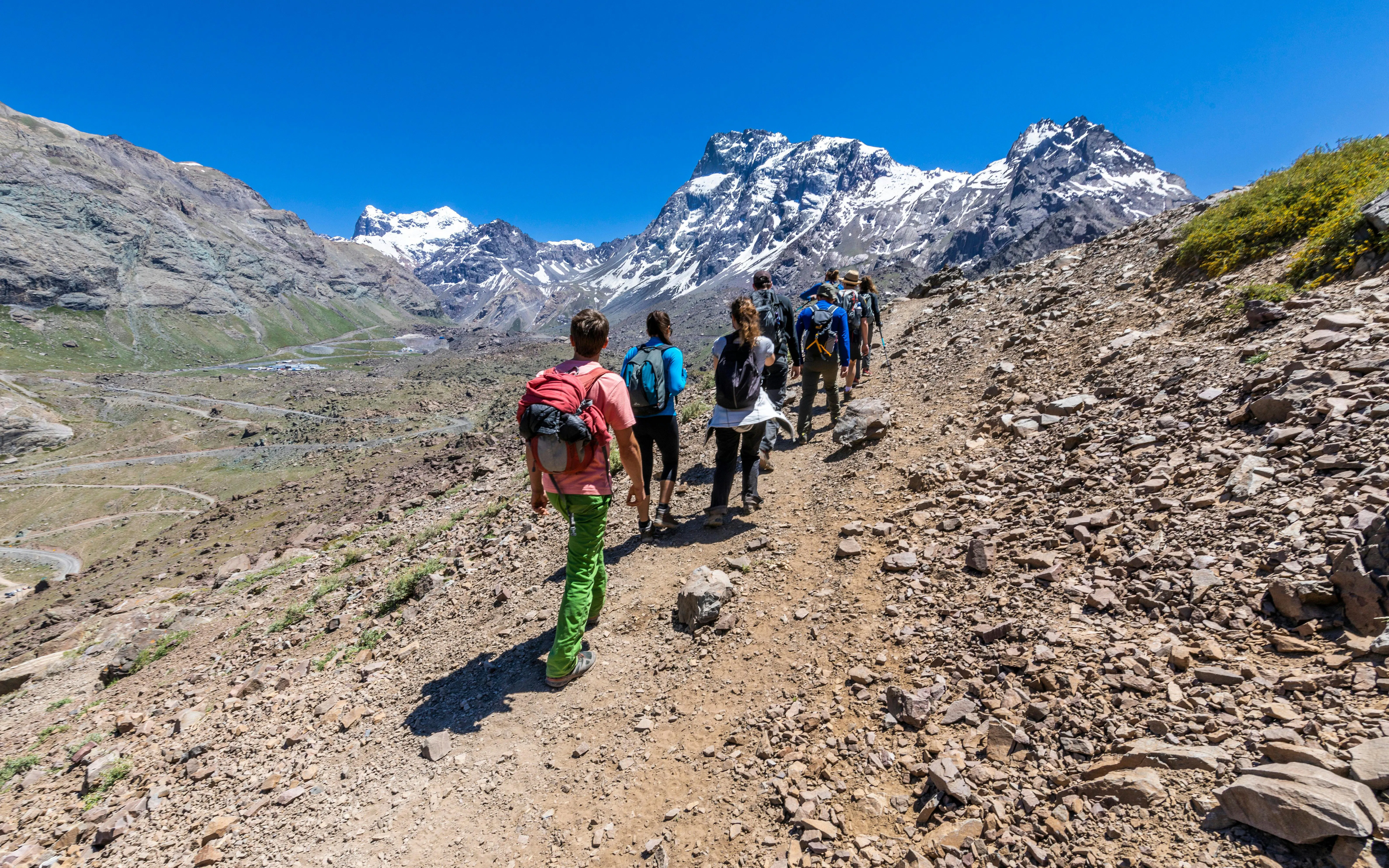 Hikers trekking through Andes valleys in Cajon del Maipo, Santiago, Chile.