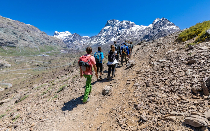 Hikers trekking through Andes valleys in Cajon del Maipo, Santiago, Chile.