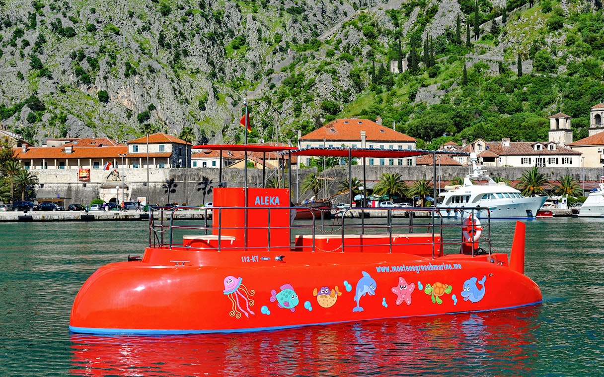 Speed boat in Boka Bay, Kotor with colorful marine designs.