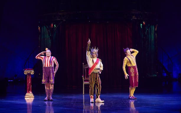 Performers in colorful costumes on stage during Kooza show in Brisbane.