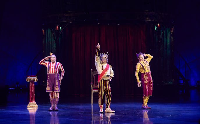 Performers in colorful costumes on stage during Kooza show in Brisbane.