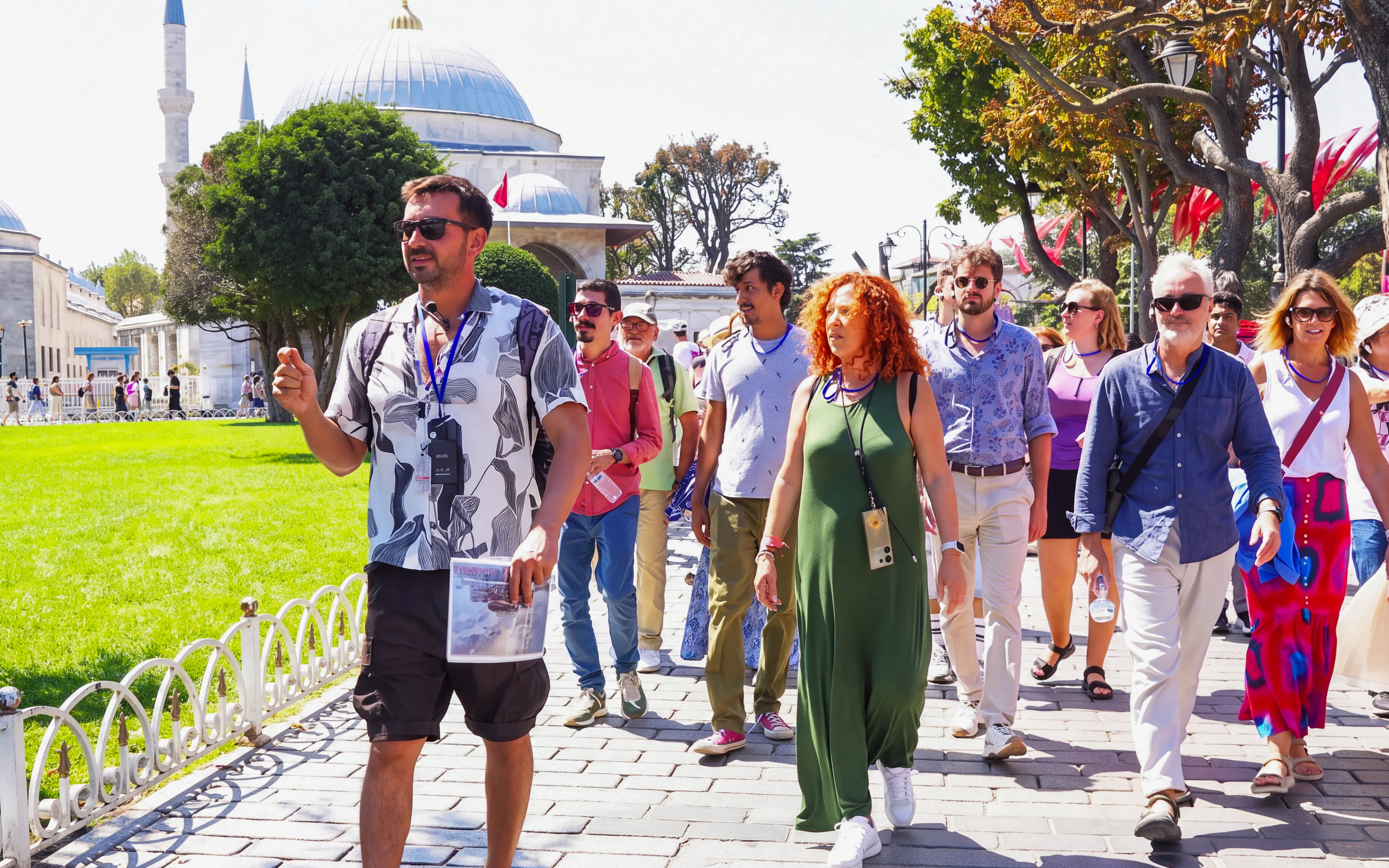 Tour group walking with guide near Istanbul's Blue Mosque.