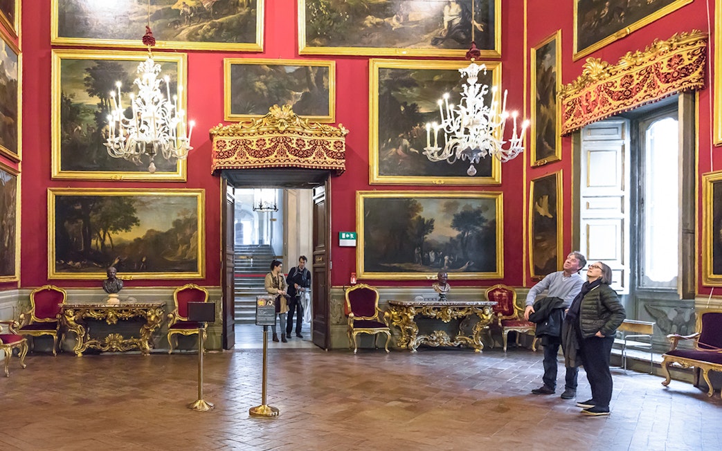 Visitors admiring artwork in the ornate Doria Pamphilj Gallery, Rome.