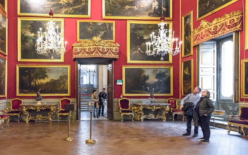 Visitors admiring artwork in the ornate Doria Pamphilj Gallery, Rome.