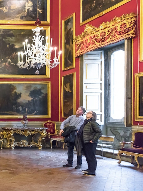 Visitors admiring artwork in the ornate Doria Pamphilj Gallery, Rome.