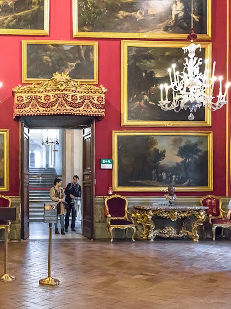 Visitors admiring artwork in the ornate Doria Pamphilj Gallery, Rome.