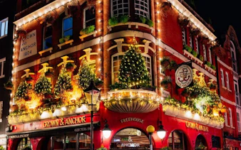 Crown & Anchor pub adorned with Christmas lights in London.