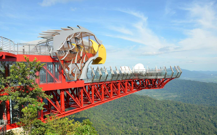 Langkawi SkyBridge with eagle-themed platform overlooking lush forest.