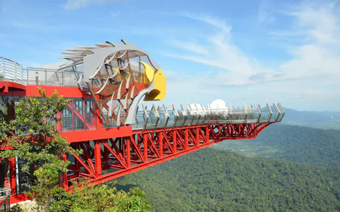 Langkawi SkyBridge with eagle-themed platform overlooking lush forest.
