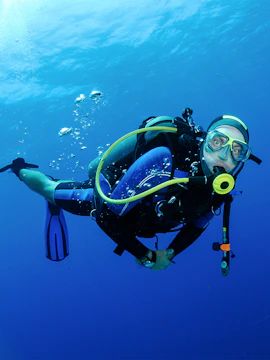 Scuba diver exploring underwater in Tanjung Benoa, Bali.