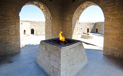 Yanardag Ateshgah Fire Temple with eternal flame in stone altar, Azerbaijan.