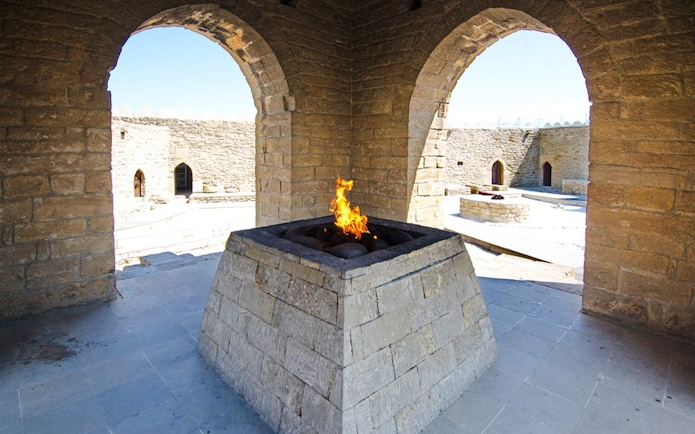Yanardag Ateshgah Fire Temple with eternal flame in stone altar, Azerbaijan.