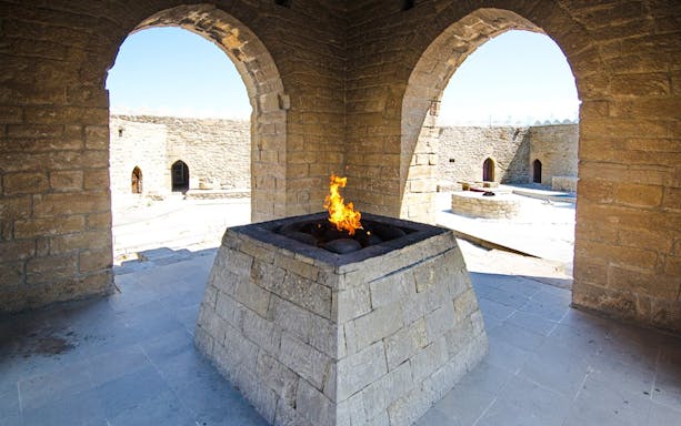Yanardag Ateshgah Fire Temple with eternal flame in stone altar, Azerbaijan.