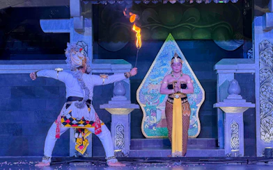 Traditional Javanese dancers perform Ramayana ballet with fire element on stage.
