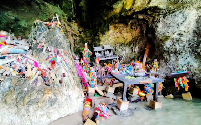 Shrine with colorful offerings inside a cave on the Krabi 4 Islands tour.