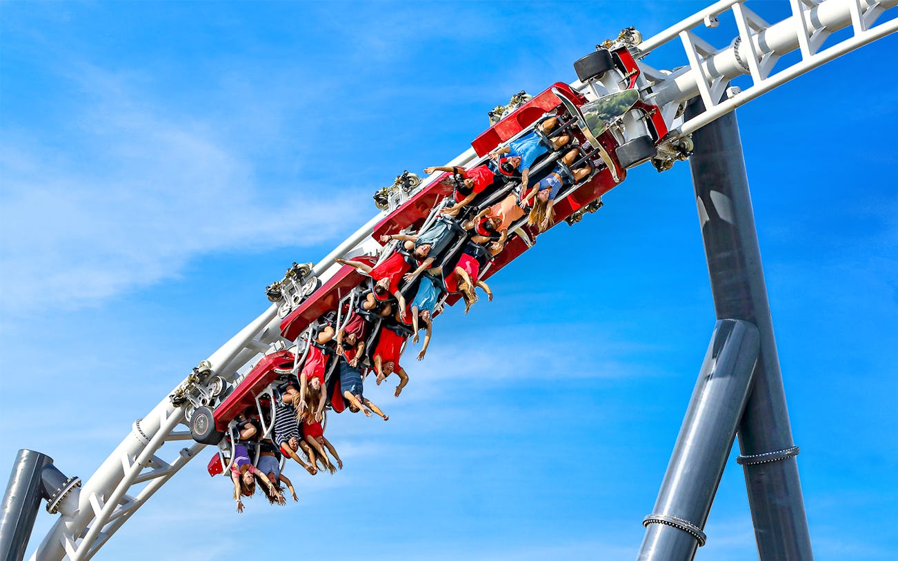 Riders upside down on Maxx Force roller coaster at Six Flags Great America.