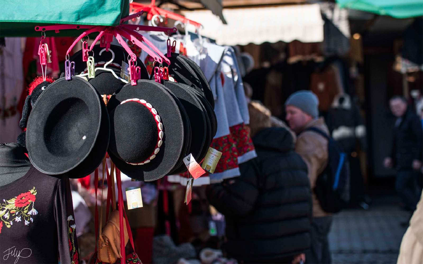 Traditional hats and embroidered clothing at a market in Zakopane, Poland.