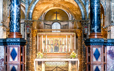 Interior of St. Mark’s Basilica altar with ornate columns and religious artwork, Venice.