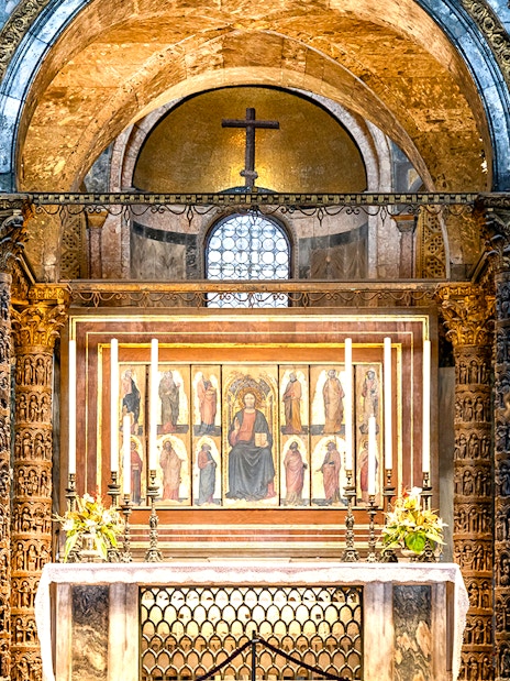 Interior of St. Mark’s Basilica altar with ornate columns and religious artwork, Venice.