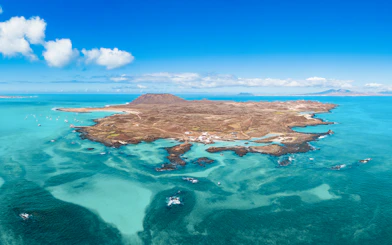 Aerial view of Isla de Lobos and turquoise waters near Corralejo, Fuerteventura, Canary Islands.