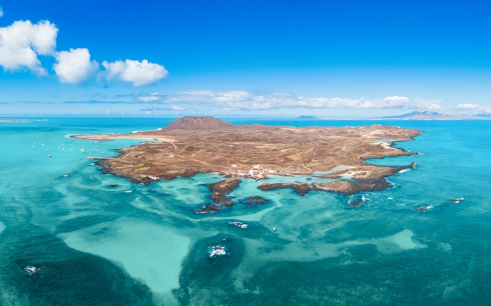Aerial view of Isla de Lobos and turquoise waters near Corralejo, Fuerteventura, Canary Islands.