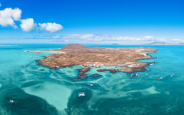 Aerial view of Isla de Lobos and turquoise waters near Corralejo, Fuerteventura, Canary Islands.