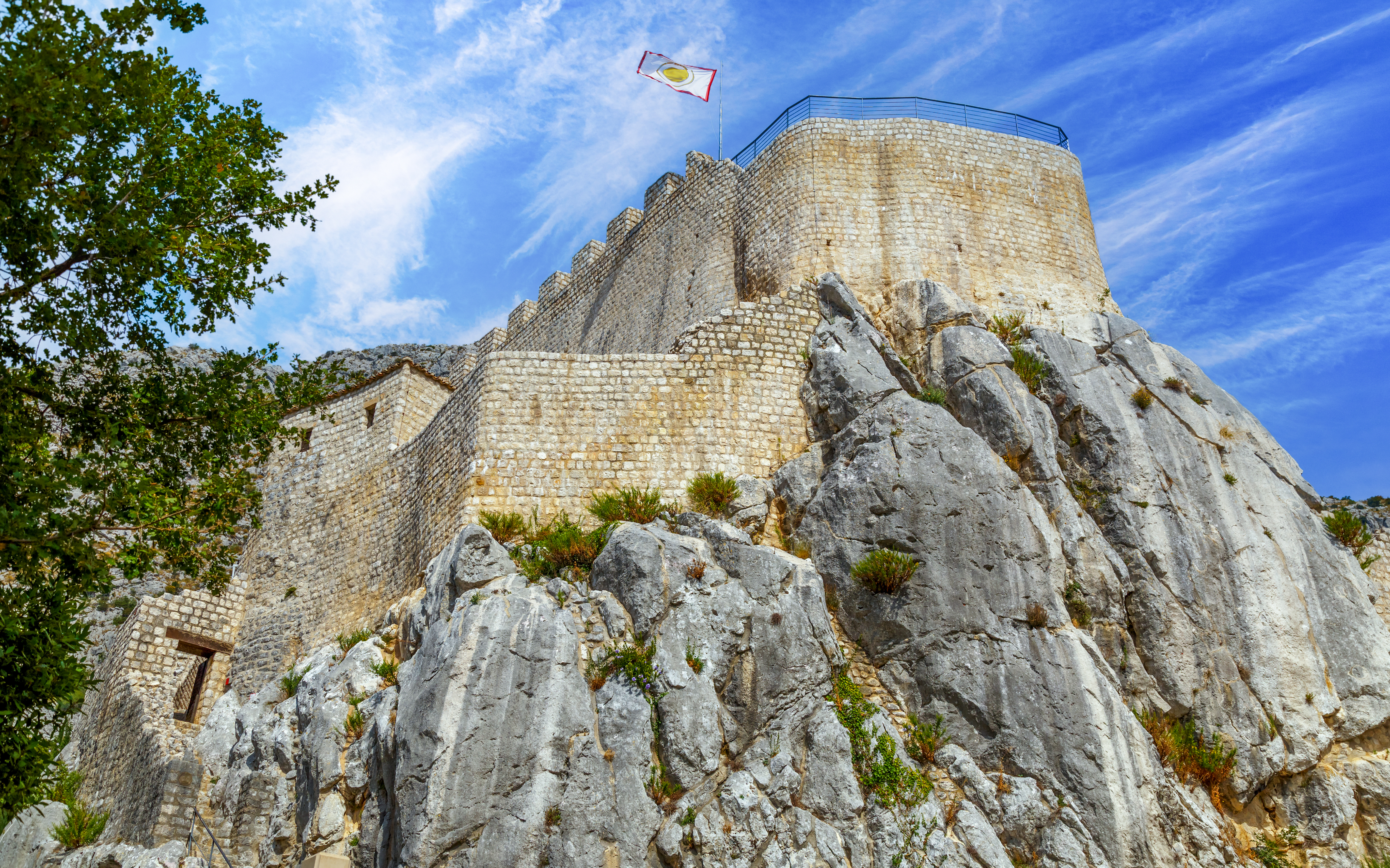 Sokol grad fortress on rocky hill under blue sky, Croatia.