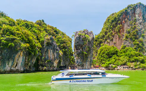 Speedboat near limestone cliffs at James Bond Island, Phang Nga Bay, Phuket.