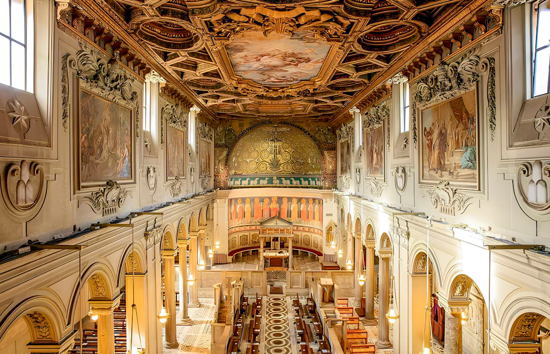 Basilica of San Clemente interior with ornate ceiling and frescoes, Rome.