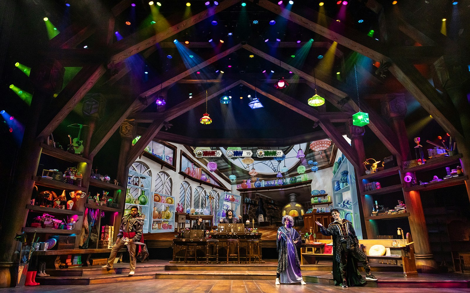 Stage set of Dungeons & Dragons: The Twenty-Sided Tavern with colorful lights and fantasy decor.