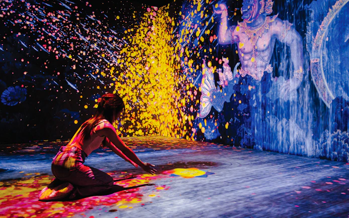 Visitor engaging with digital art at Akara Sky Hanuman, Bangkok.