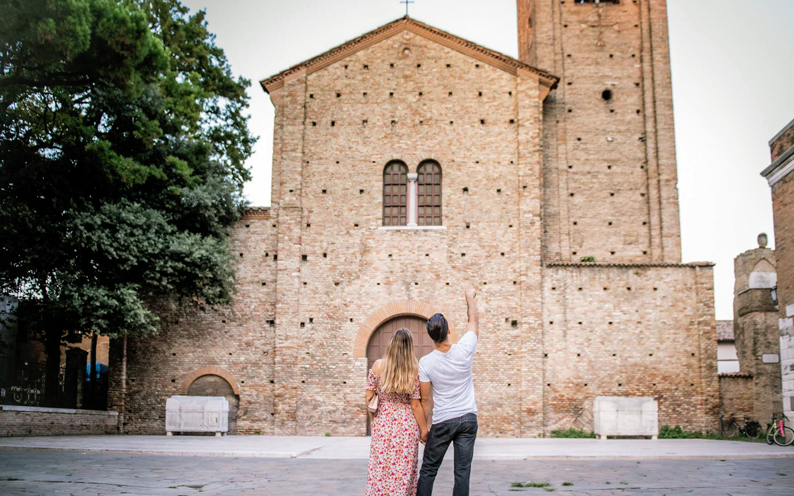 Couple admiring Basilica of Sant'Apollinare in Classe, Ravenna on UNESCO tour.