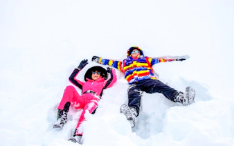 Two people making snow angels at Valle Nevado, Santiago.