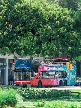 Barcelona Bus Turistic double-decker on city street, offering hop-on hop-off tour.