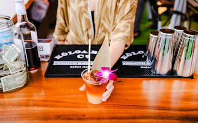 Bartender serving tropical drink at Mauka Warriors Luau in Hawaii.