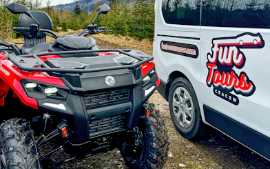 Quad bike and tour van in Zakopane forest setting.