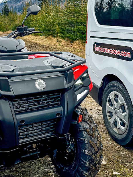 Quad bike and tour van in Zakopane forest setting.