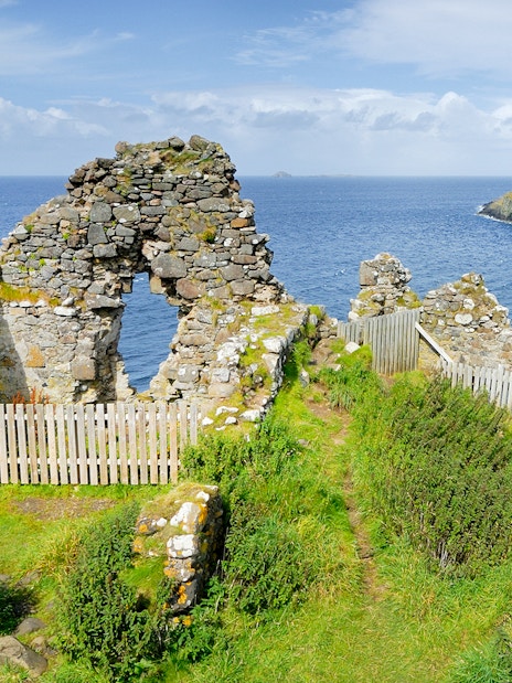 Ruins overlooking the sea on the Isle of Skye, part of The Highlands & Loch Ness Tour.