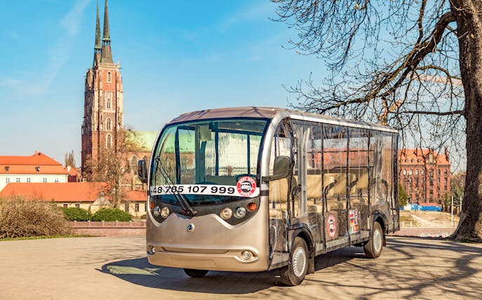 Electric car for Wroclaw 2-hour private guided tour with cathedral in background.