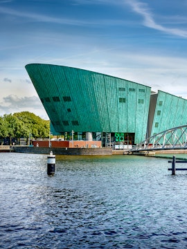 NEMO Science Museum in Amsterdam with its distinctive green architecture by the water.